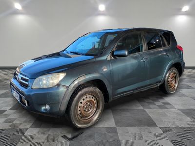 a picture of a blue toyota rav parked in a garage