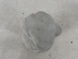 a close up view of a small white object in the snow