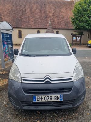 a small white van parked in a parking lot
