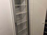 an empty refrigerator in the corner of a room