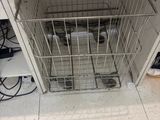 an image of a dog in a cage in a kitchen