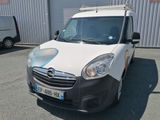 a white van parked in front of a building