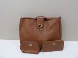 brown leather handbag with two matching wallets on a white surface