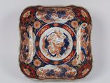 a close up of a plate with a flower design on it