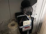 an image of a small room with a lot of stuff on the floor