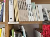 a bookshelf with many books on it in a room