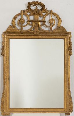 an image of a gold framed mirror on a white wall