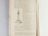 an open book with a drawing of a clock on top of it