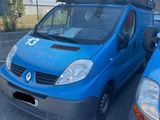 a blue van parked next to another blue van in a parking lot