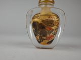 a glass bottle that has a picture of a horse in it