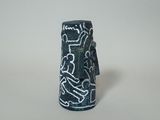 a small black object with a white design on it