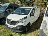 three vans parked next to each other in the grass