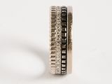 silver ring with black and white diamonds on a white background