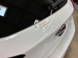 a close up of a white car with a sticker on it
