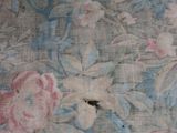 an image of a close up of a bed with a floral pattern on it