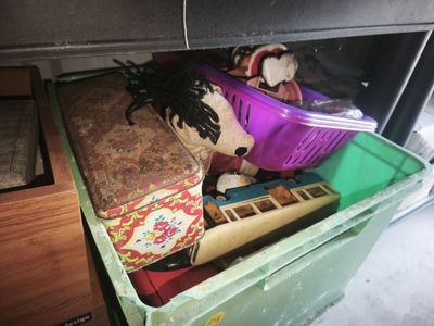 a green box with a stuffed animal inside of it