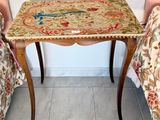 a small table with a bird on it in a room