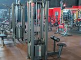 a gym with a lot of machines in the room
