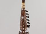 a wooden instrument hanging from a string on a wall