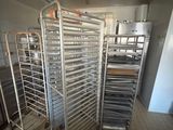 many trays of food that are on a rack in the kitchen