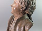 statue of a bust of a man with a scarf on his neck