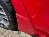 a close up of a tire on a red car