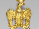 an image of a gold eagle with a crown on it ' s head