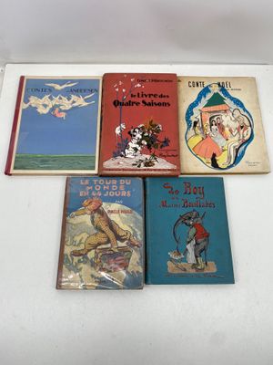 several children ' s books are lined up on a white surface