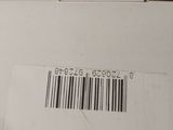 an open box with a barcode on it sitting on a table