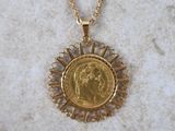 a close up of a gold coin on a gold chain