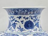 a blue and white vase sitting on a table