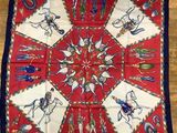 a red and blue banda with a picture of a horse and rider on it