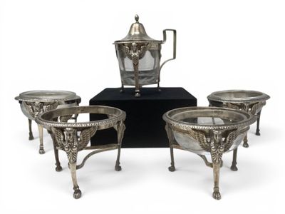 three silver plated coffee pots and four cups on a stand