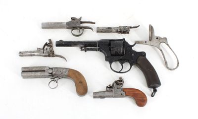 many different types of guns on display on a white surface
