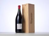 the bottle of red wine is next to a wooden box