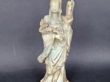 an image of a statue of a woman holding a bird