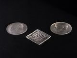 three different types of silver coins on a black surface