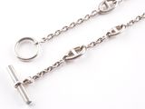 silver plated chain with a cross on it and a ring on the end
