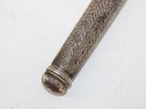 an old metal pipe with a wooden handle sitting on a white surface