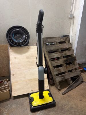 a vacuum that is sitting on the floor next to a pallet