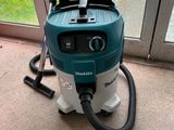 a vacuum that is sitting on the floor by the window