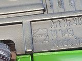 a close up of a person ' s hand holding a green toy gun