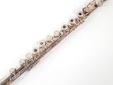 a flute that is sitting on a white surface
