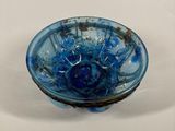 a blue bowl sitting on a table with a white background