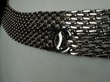 a close up of a silver belt with a chain around it