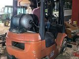 a forklift truck that is parked in a garage