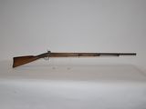 a rifle on a table with a white background