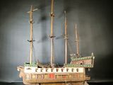 a wooden model of a ship on a table