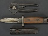 two knives and a pliers are on a black surface