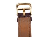 an image of a brown leather watch strap with a gold buckle